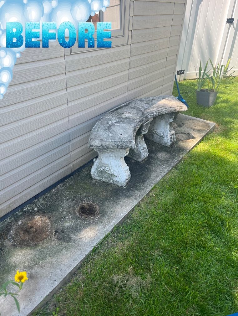 Concrete pad and stone bench before pressure washing